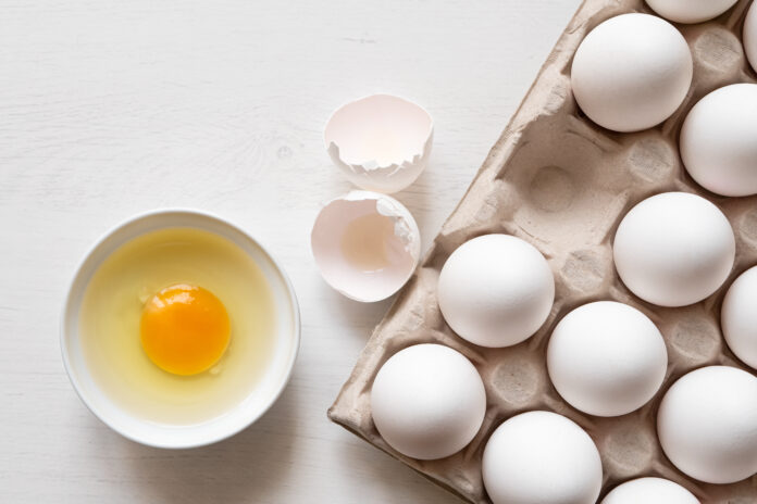 Eggs in a tray and broken egg.