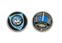 Minister di Husticia a ricibi moneda di reconocemento di CEA